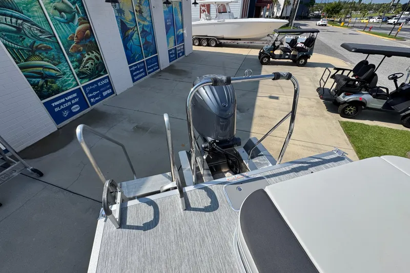 Slide: The Image of 2026 Bennington 22 SSB pontoon boat with motor, docked near marine store. - 35