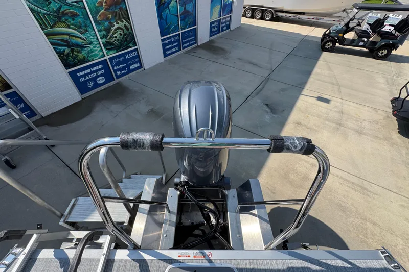 Slide: The Image of 2026 Bennington 22 SSB boat with motor and ladder, displayed outdoors. - 36