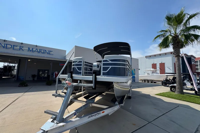Slide: The Image of 2026 Bennington 22 SSB pontoon boat on trailer at a marine dealership. - 5