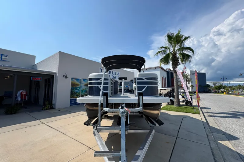 Slide: The Image of 2026 Bennington 22 SSB pontoon boat on trailer outside tackle shop. - 6