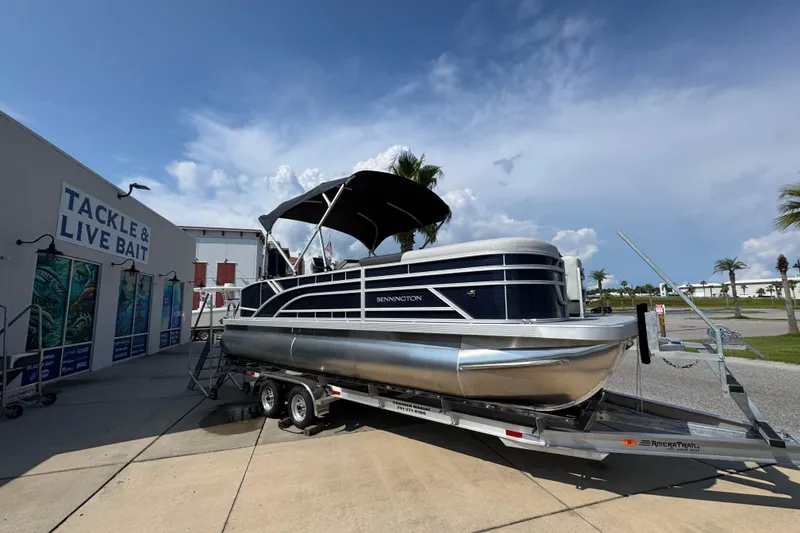 Slide: The Image of 2026 Bennington 22 SSB pontoon boat on trailer near tackle shop. - 8
