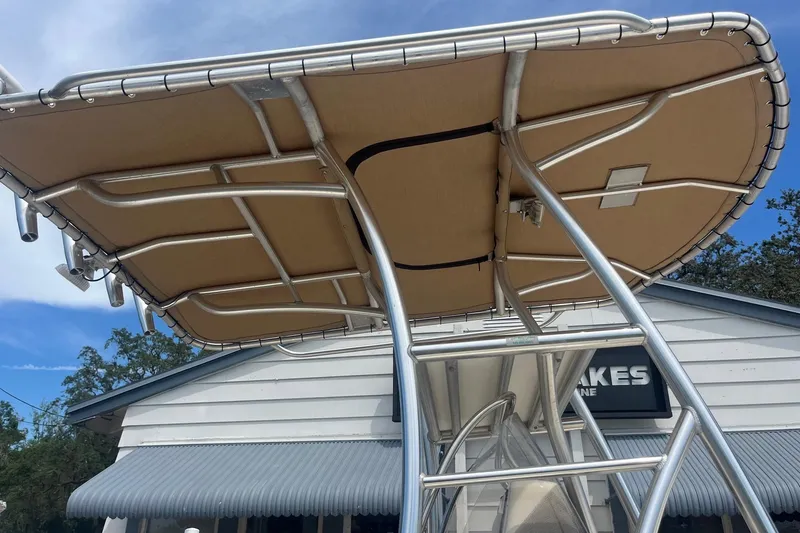 Slide: The Image of 2009 Scout 221 Winyah Bay boat T-top with metal frame and canvas cover. - 10