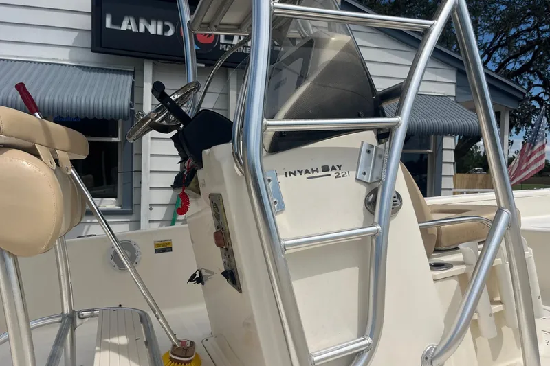 Slide: The Image of 2009 Scout 221 Winyah Bay boat interior with steering wheel and seating. - 12