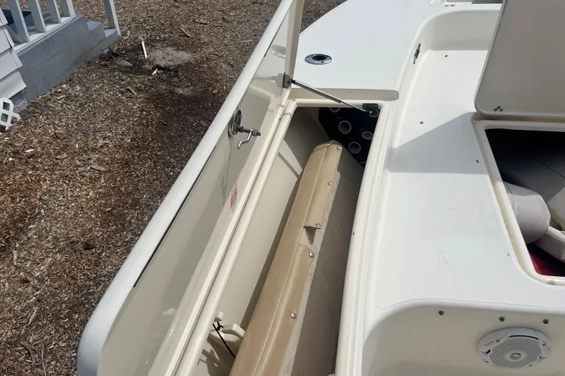 Slide: The Image of 2009 Scout 221 Winyah Bay boat interior with open storage compartment. - 3