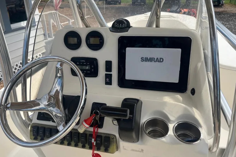 Slide: The Image of 2009 Scout 221 Winyah Bay boat console with Simrad display and steering wheel. - 7