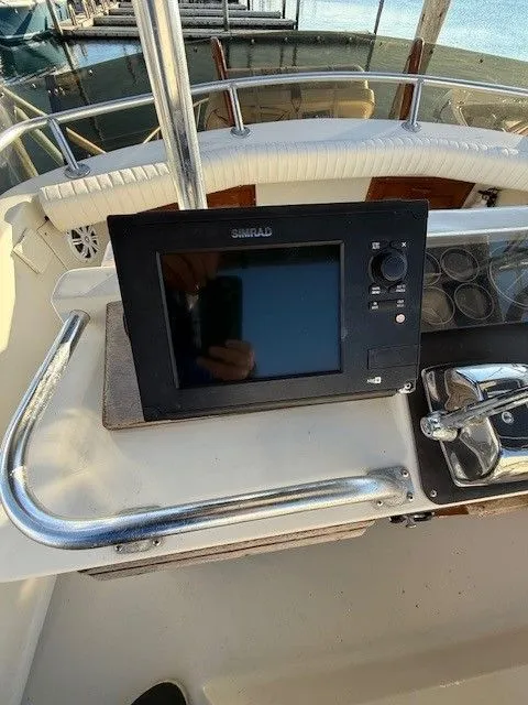 Slide: The Image of 1988 Blackfin 32 Flybridge helm with Simrad navigation system and controls. - 14
