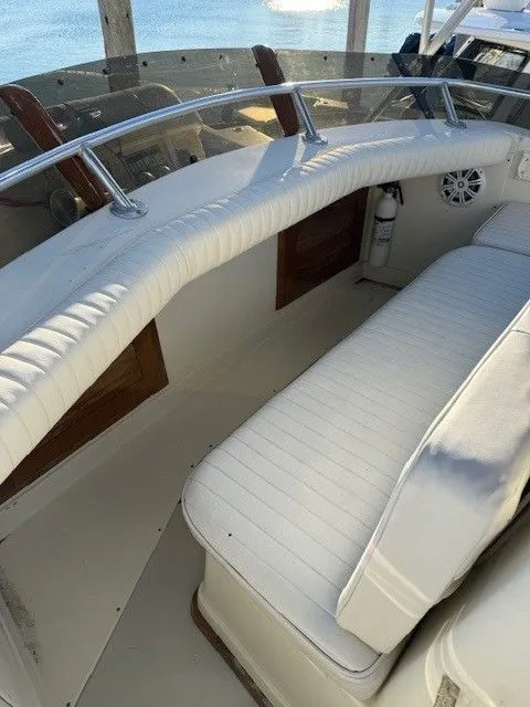 Slide: The Image of 1988 Blackfin 32 Flybridge interior with white seating and wooden accents. - 17