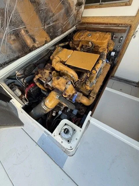 Slide: The Image of Engine compartment of a 1988 Blackfin 32 Flybridge boat, showcasing detailed machinery. - 29