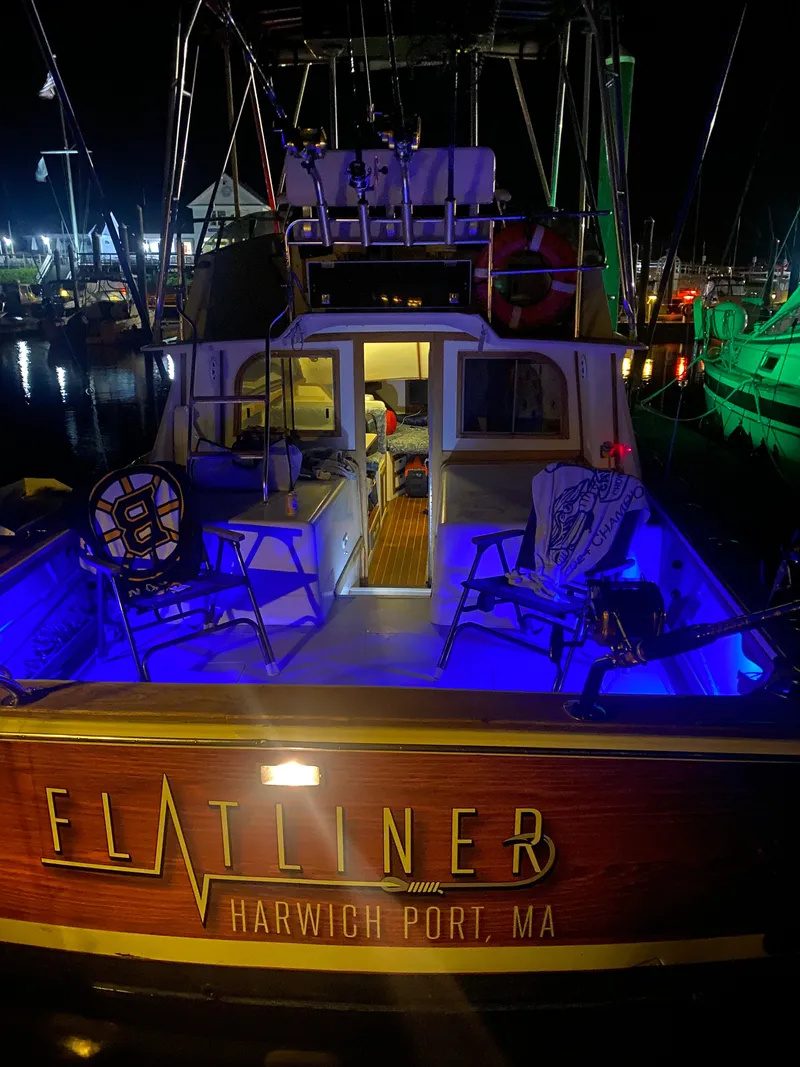 Slide: The Image of 1988 Blackfin 32 Flybridge boat docked, featuring spacious deck and flybridge under clear blue sky. - 3