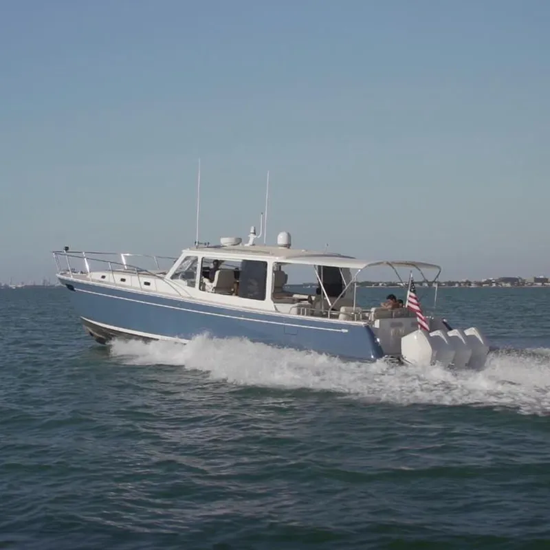 The Image of 2021 MJM 53z boat cruising on open water with American flag. - 0