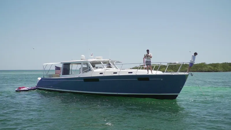 Slide: The Image of 2021 MJM 53z yacht on clear water with people enjoying the deck. - 13