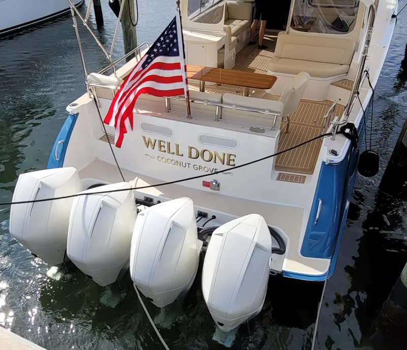 Slide: The Image of 2021 MJM 53z yacht with four engines, American flag, docked at Coconut Grove. - 14
