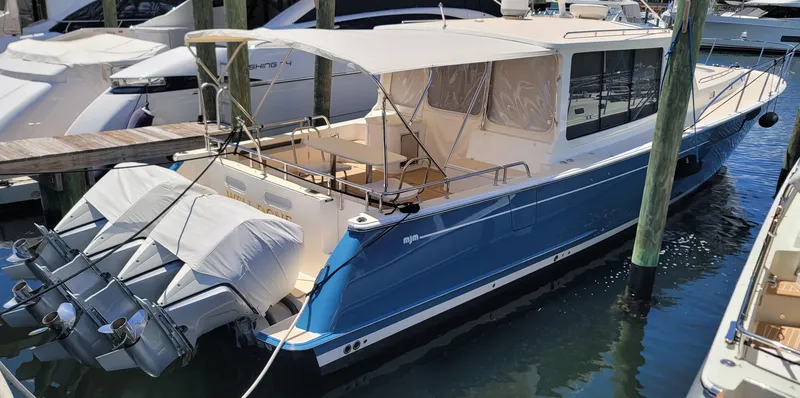 Slide: The Image of 2021 MJM 53z yacht docked with covered outboard motors. - 15