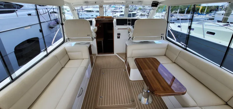 Slide: The Image of Luxurious interior of a 2021 MJM 53z yacht with elegant seating and wooden table. - 16