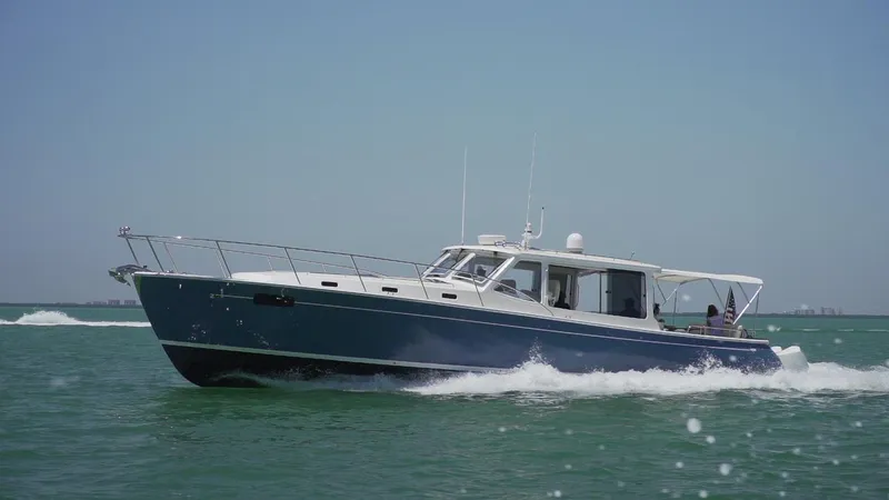 The Image of 2021 MJM 53z yacht cruising on open water under clear skies. - 2