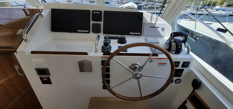 Slide: The Image of Helm of 2021 MJM 53z boat with steering wheel and navigation controls. - 23