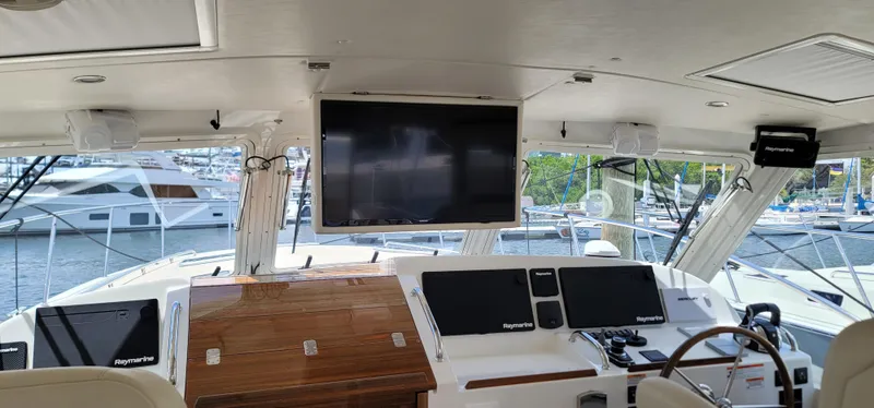 Slide: The Image of Interior view of 2021 MJM 53z yacht cockpit with navigation screens and steering wheel. - 25