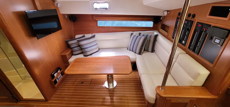 Slide: The Image of Luxurious 2021 MJM 53z yacht interior with plush seating, wooden table, and modern amenities. - 27