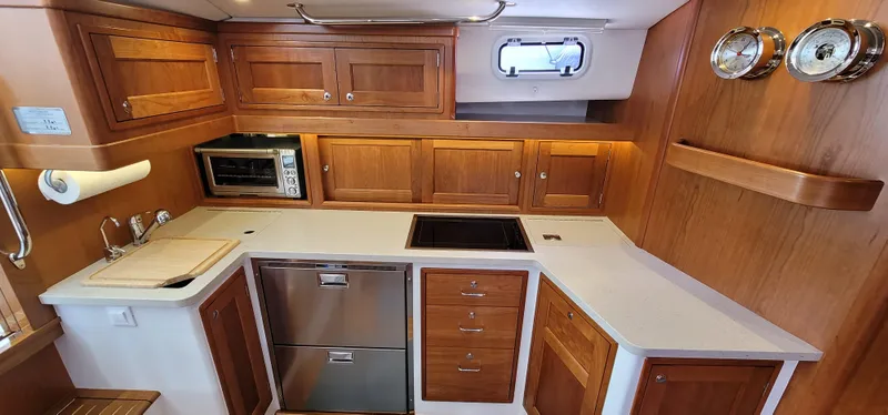 Slide: The Image of Luxurious 2021 MJM 53z yacht kitchen with wood cabinetry and modern appliances. - 29