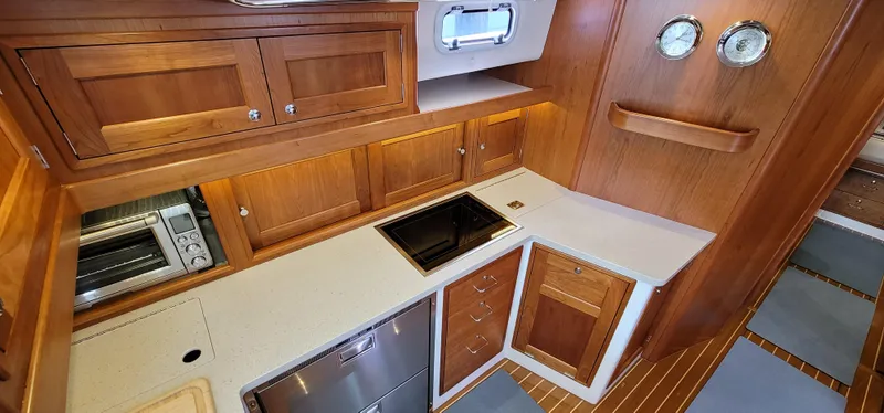 Slide: The Image of Luxurious 2021 MJM 53z yacht kitchen with wood cabinetry and modern appliances. - 30