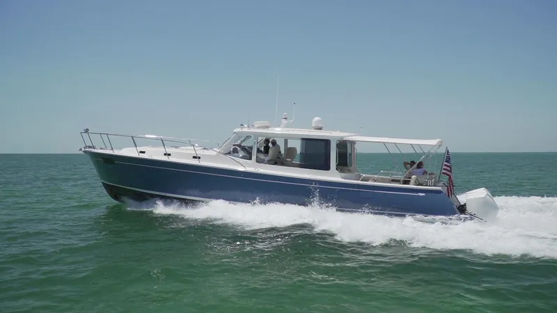 Slide: The Image of 2021 MJM 53z yacht cruising on open water under clear blue skies. - 4