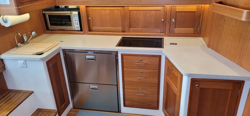 Slide: The Image of Modern kitchen in 2021 MJM 53z yacht with wood cabinets and stainless steel appliances. - 42