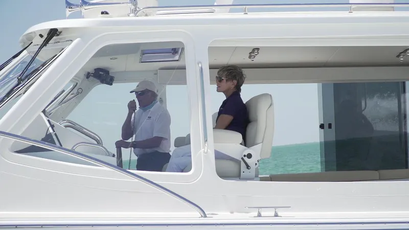 Slide: The Image of 2021 MJM 53z yacht with two people in the cabin, cruising on the ocean. - 9