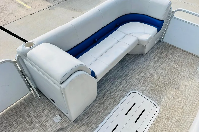 Slide: The Image of 2019 SunCatcher V322 RF boat interior with open storage compartment and cushioned seating. - 13
