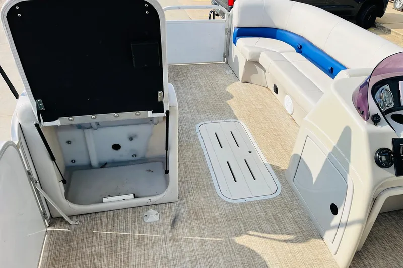 Slide: The Image of 2019 SunCatcher V322 RF boat seating with storage compartment, featuring white and blue upholstery. - 14