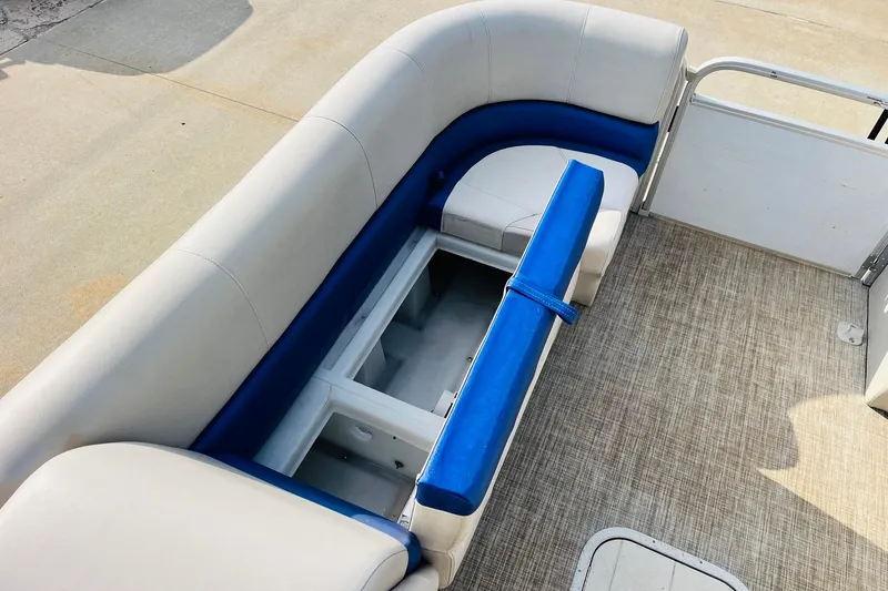 Slide: The Image of 2019 SunCatcher V322 RF boat interior with white and blue seating on deck. - 15