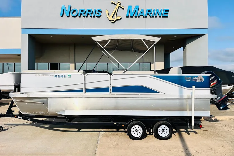 Slide: The Image of 2019 SunCatcher V322 RF pontoon boat on trailer, sunny day, clear blue sky. - 2