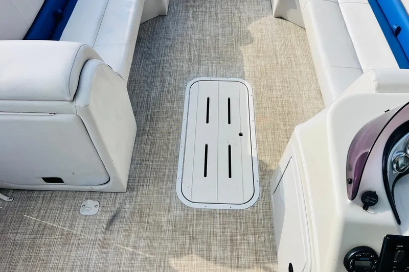 Slide: The Image of 2019 SunCatcher V322 RF pontoon boat interior with plush seating and steering console. - 20
