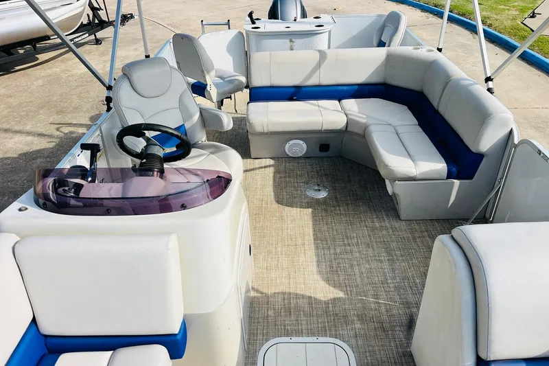 Slide: The Image of 2019 SunCatcher V322 RF boat interior with open storage compartment and cushioned seating. - 22