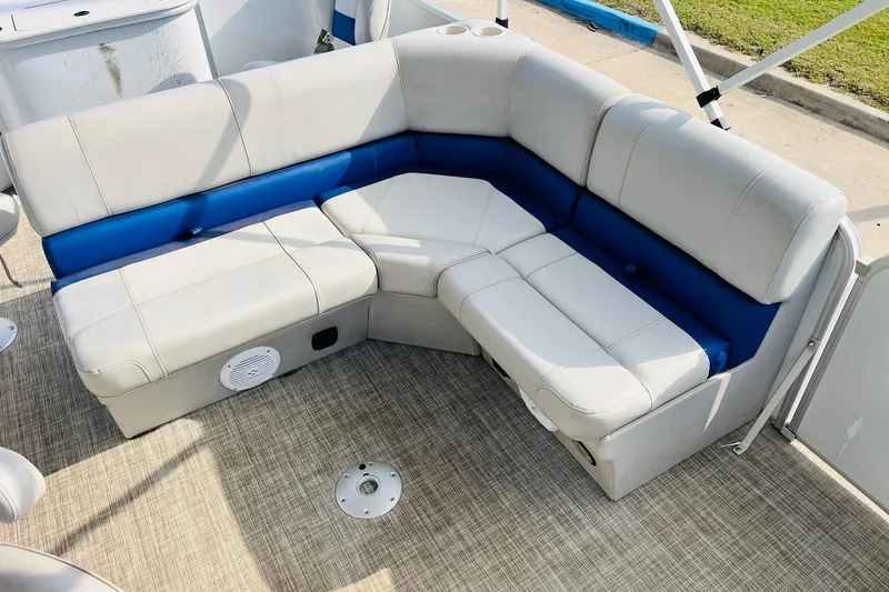 Slide: The Image of 2019 SunCatcher V322 RF boat interior with open storage compartment and cushioned seating. - 23
