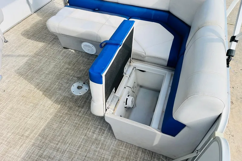 Slide: The Image of 2019 SunCatcher V322 RF boat interior with white and blue cushioned seating. - 24