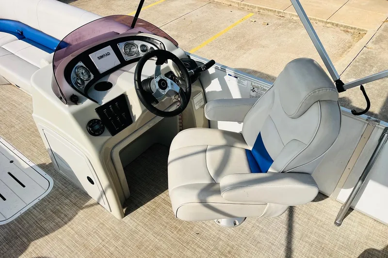Slide: The Image of 2019 SunCatcher V322 RF boat interior with seating and motor, docked on concrete. - 27