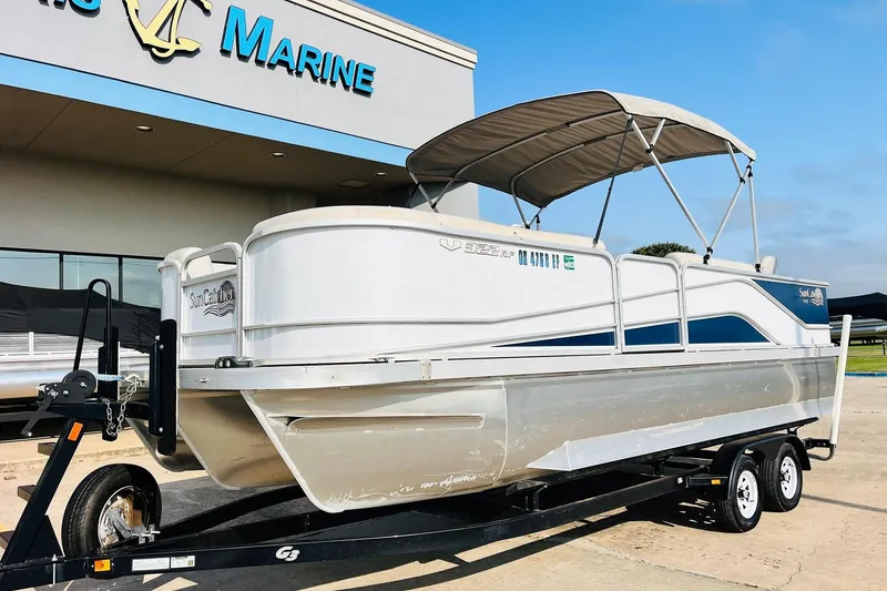 Slide: The Image of 2019 SunCatcher V322 RF pontoon boat on trailer, featuring a canopy and sleek design. - 3