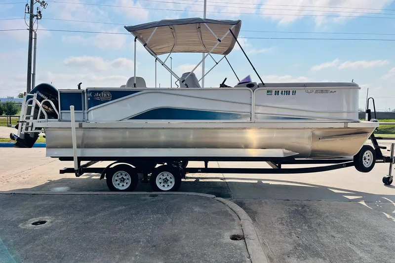 Slide: The Image of 2019 SunCatcher V322 RF pontoon boat with outboard motor and ladder, parked at dealership. - 6