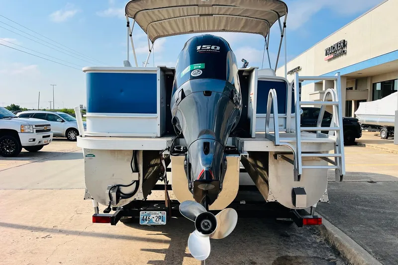 Slide: The Image of 2019 SunCatcher V322 RF boat with Yamaha motor and trailer, parked on concrete. - 8