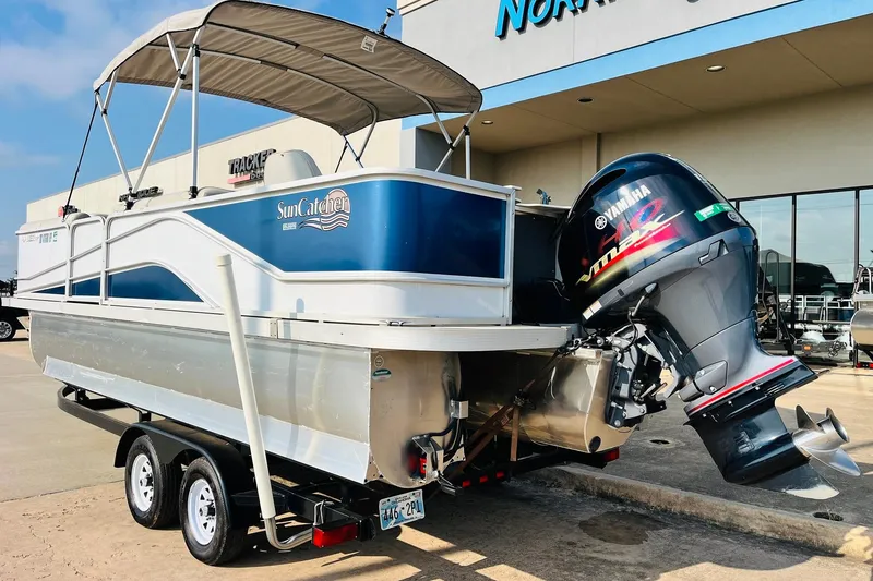 Slide: The Image of 2019 SunCatcher V322 RF pontoon boat interior with seating and steering console. - 9