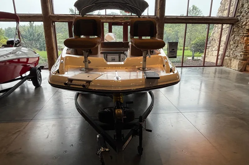 Slide: The Image of 2025 Tahoe 2150 boat displayed indoors with scenic window view. - 1
