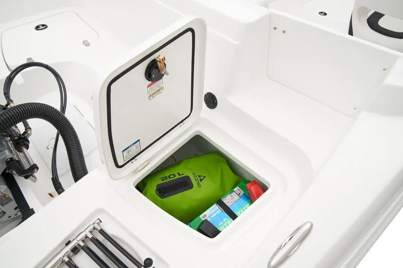 Slide: The Image of Manufacturer Provided Image: 2025 Tahoe 2150 boat storage compartment with green bag and supplies. - 32