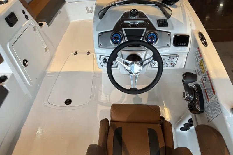 Slide: The Image of 2025 Tahoe 2150 boat cockpit with steering wheel, gauges, and control panel. - 5