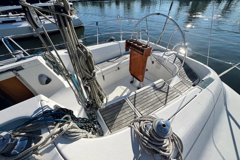 Slide: The Image of Cockpit of a 1994 Beneteau First 35s7 sailboat, featuring ropes and steering wheel. - 11