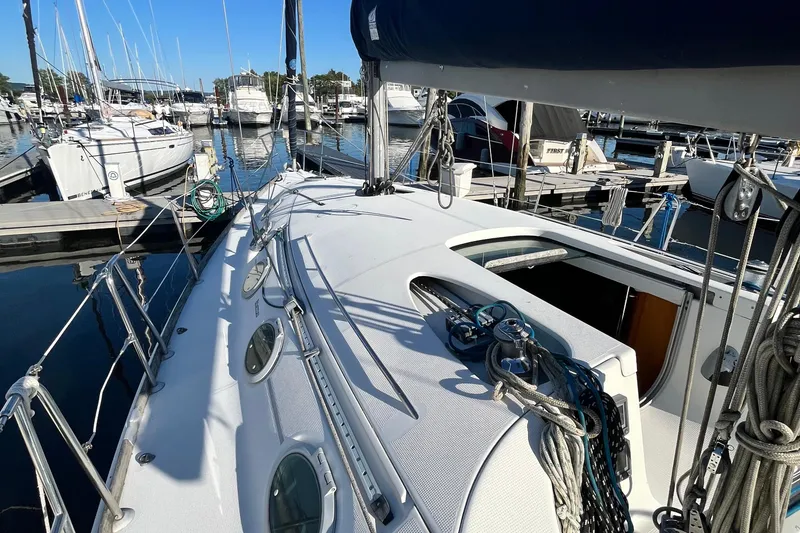 Slide: The Image of 1994 Beneteau First 35s7 sailboat docked at marina, showcasing deck and rigging. - 12