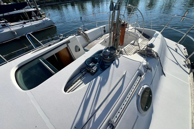 Slide: The Image of 1994 Beneteau First 35s7 sailboat deck with winches and ropes in marina. - 13