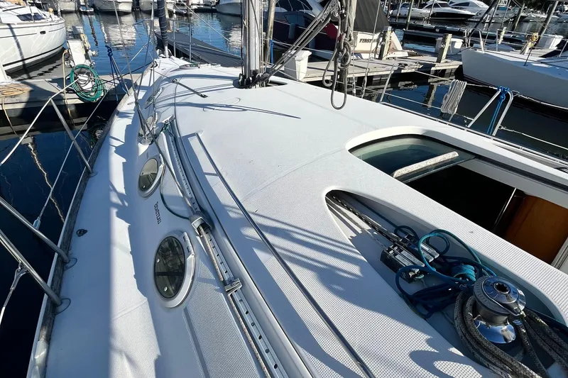 Slide: The Image of 1994 Beneteau First 35s7 sailboat deck with winch and ropes at marina. - 14