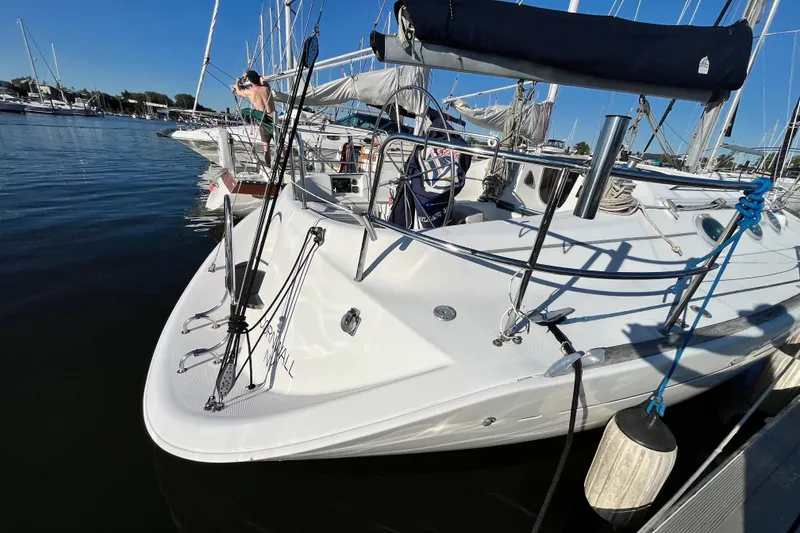 Slide: The Image of Sailboat Beneteau First 35s7, 1994 model, docked at marina under clear blue sky. - 3