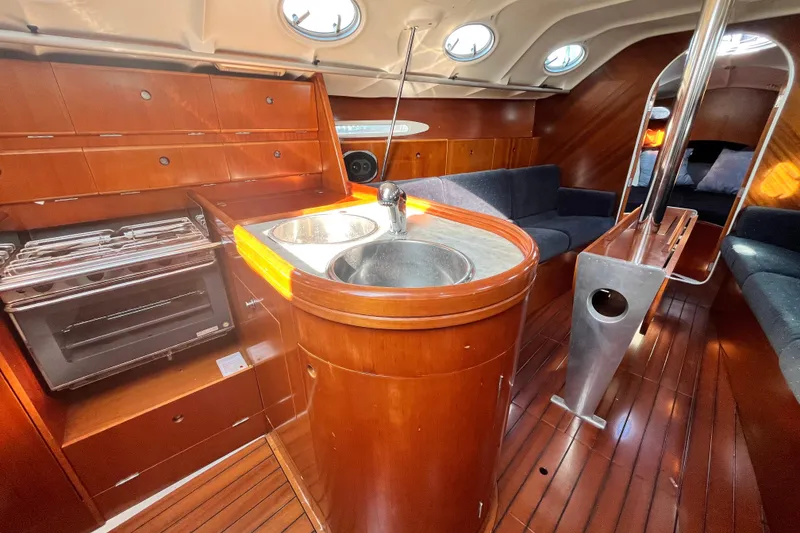 Slide: The Image of Interior of 1994 Beneteau First 35s7 yacht with wood finish and compact kitchen. - 43