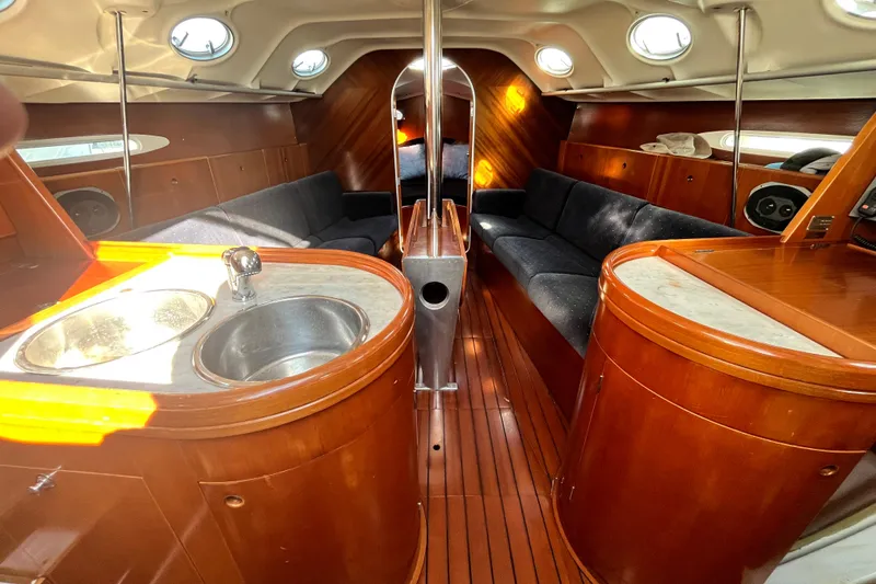 Slide: The Image of Interior of 1994 Beneteau First 35s7 yacht with wood finish and modern amenities. - 44